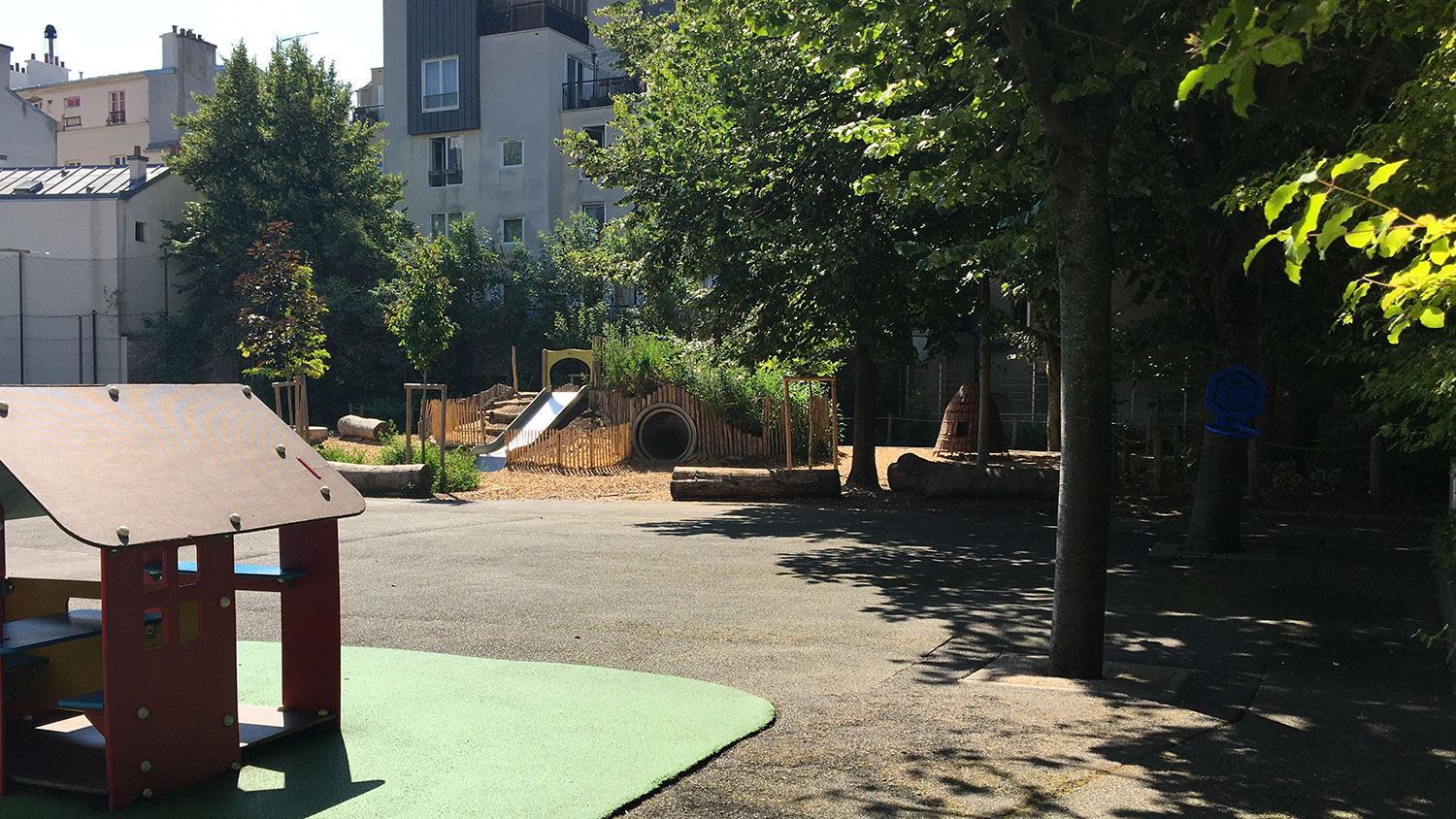 Des jeux : tunnels, toboggan, escaliers sont installés sur un talus sur la partie végétalisée de la cour Tandou.